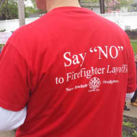 <p>Dozens of protesters wore red shirts during a rally May 3 that said: &quot;Say &#x27;NO&#x27; to Firefighter Layoffs.&quot; The Village of Rye Brook filed a lawsuit against the Village of Port Chester on Tuesday claiming a breach of contract for firefighter services.</p>
