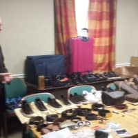 <p>Harrison Police Chief Anthony Marraccini shows stolen goods and fake ID recovered this week after arresting three suspects in a car break-in Sunday in Purchase. In addition to cash and cellphones, police recovered luxury handbags, belts and shoes.</p>