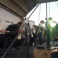 <p>The Mighty Spectrum Band, a local rock group, plays for a large crowd at Clarkstown&#x27;s Fourth of July celebration.</p>