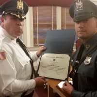 <p>Officer Walter Kumka receives honor from the chief.</p>