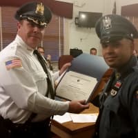 <p>Officer Devin Rivera receives honor from the chief.</p>