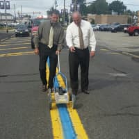 <p>Saddle Brook Police Chief Robert Kugler, left, and Mayor Robert White help paint township&#x27;s thin blue line.</p>
