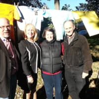 <p>Trumbull Rotary Club President Ed Gillespie, Center for Family Justice President and CEO Debra A. Greenwood and Rotarians Sue Horton and Steve Hodson stand in front of The Clothesline Project in Trumbull.</p>