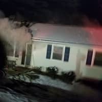 <p>A fire rips through this home at 44 Fleetwood Drive in Danbury early Sunday.</p>