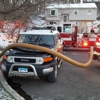 <p>Danbury firefighters battling a blaze at a home at 44 Fleetwood Drive in Danbury early Sunday had to work around a car parked in front of the closest hydrant.</p>