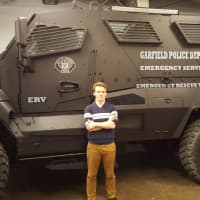 <p>The large size of the MRAP is apparent in close proximity, towering over the average person (seen here with reporter Arthur Augustyn). The vehicle was renamed to &quot;Emergency Service Unit&quot; to detach it from its military past.</p>