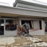 <p>The facade is damaged at Naked Greens on Route 7 in Wilton after a car slammed into the building Saturday.</p>