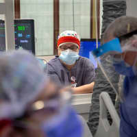 <p>Marilyn Monzon, RN, looks on in a COVID-19 room at Holy Name Medical Center during the first weeks of the COVID-19 Pandemic.</p>