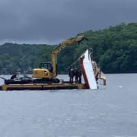 <p>The operator of a personal watercraft was hospitalized after crashing into a 25-foot boat on Lake Hopatcong and causing both vessels to sink Monday night, state police confirmed.</p>