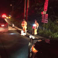 <p>Weston volunteer firefighters work at the scene of a two-vehicle crash late Saturday.</p>