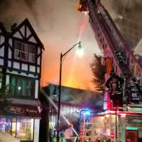 <p>Firefighters douse an alleyway to keep blaze from spreading to F&amp;D Frame Shop.</p>