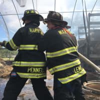 <p>The Warwick Fire Department works to extinguish a greenhouse fire on Wednesday.</p>