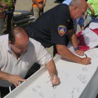 <p>Police and other officials sign the last beam before the &quot;topping-off&quot; ceremony Monday for the new headquarters for the Stamford Police Department.</p>