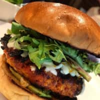 <p>Chorizo and shrimp burger with melty Oaxaca cheese, avocado, and greens on a brioche at The Whitlock in Katonah.</p>