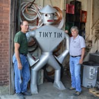 <p>Glen Mills and Bill Gesner flank the tin man in their Hillsdale sheet metal shop.</p>