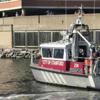 <p>Stamford fire department divers search the waters of Stamford Harbor for a missing swimmer.</p>