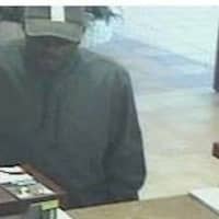 <p>Brookfield police released this photo of the suspect in a Friday bank robbery. The man is 5-foot-10 with a medium build and wearing a black baseball cap with a distinctive stripe.</p>