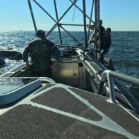 <p>Fairfield marine police respond to the 2A navigational marker off Black Rock Harbor to rescue two men whose boat overturned.</p>
