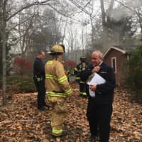 <p>Weston and Fairfield firefighters respond to a blaze at a house on Saw Mill Road in Weston on Saturday.</p>