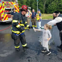 <p>A little girl and her father brought water to the scene for the firefighters.</p>