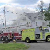 <p>Fire fighters at a working structure fire on the corner of State Route 42 and Fraser Road in Lake Kiamesha.</p>