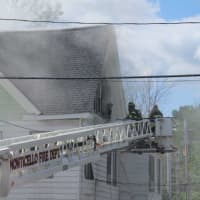<p>Firefighters rescue a man from the 3rd floor of the rooming house located at 428 Fraser Road in Kiamesha Lake.</p>