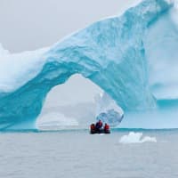 <p>Some icebergs are blue. The color occurs mostly in very old ice from a very deep glacier and is the result hundreds or even thousands of years of compression and ongoing thawing and refreezing of the ice. Here we are going under this ice tunnel.</p>