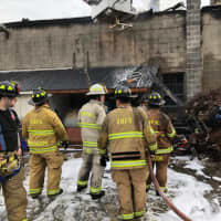<p>Firefighters tackle a blaze in a commercial building on Paul Street in Bethel.</p>