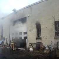 <p>Firefighters tackle a blaze in a commercial building on Paul Street in Bethel.</p>