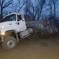 <p>The bed of a dump truck overturned while workers were unloading cargo in New Hempstead.</p>