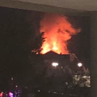 <p>A large fire burns in a condo building at 100 Richards Ave. in Norwalk late Monday afternoon. Eric Hansen captured this photo from his nearby office at 40 Richards Ave.</p>