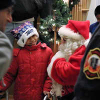 <p>Austin, 8 of Moonachie, was surprised by firefighters and Santa Claus on Saturday.</p>