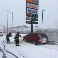 <p>Fairfield firefighters douse a burning car on I-95 northbound near the rest area during Thursday&#x27;s nor&#x27;easter.</p>