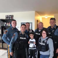 <p>Raphael was wearing his police apparel when he opened the door to greet the officers Tuesday. Fair Lawn&#x27;s Luis Vazquez, far left, organized the ordeal.</p>