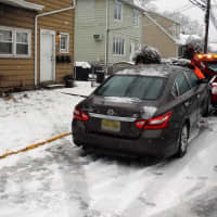 <p>The four-door Nissan sedan was towed after crashing into the Central Avenue multi-family home.</p>