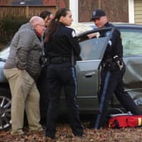 <p>First responders aid the driver of the sedan involved in the Glen Rock crash on Tuesday.</p>