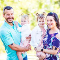 <p>Christopher and Shanann Watts with their daughters, Bella and Celeste. Christopher was taken into custody in connection with the murder of his family.</p>