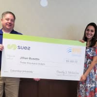 <p>SUEZ’s Tim Michaelson presents a $3,000 SUEZ-NAWC scholarship to Jillian Busetto of Pomona.</p>