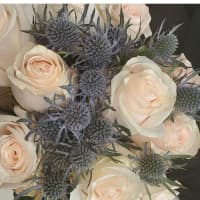 <p>The arrangement -- blush pink roses with baby&#x27;s breath.</p>