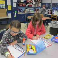 <p>Fourth-graders at the Carrie E. Tompkins Elementary School write letters of thanks to servicemen and women.</p>