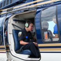 <p>Connor Hayhurst aboard a New York State Police helicopter.</p>