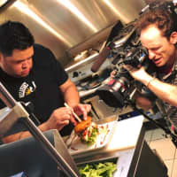 <p>Chef Danny Fabian puts the finishing touches on Callahan&#x27;s Now and Tater burger.</p>