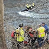 <p>First responders work to save a man stranded in the river.</p>