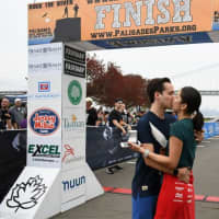 <p>Moments after crossing the finish line, Thomas Susarchick proposes to girlfriend Ariel Hidalgo at Rock the River Race in Fort Lee.</p>