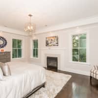 <p>The master bedroom is complete with a fireplace and balcony.</p>