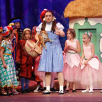 <p>Dorothy (Kate Murphy) and munchkins from the cast of New Canaan High School&#x27;s production of &quot;The Wizard of Oz.&quot;</p>