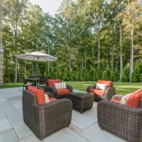 <p>The patio at 14 Norfield Road is perfect for warm weather entertaining. The master bedroom&#x27;s balcony can be seen as well.</p>