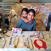 <p>Guadalupe, a 17-year-old former slave, and her daughter, in front of the jewelry business she hopes will remove them from the cycle of slavery,</p>