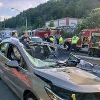 <p>A car went airborne after striking a guardrail on the Saw Mill River Parkway in Dobbs Ferry, landing on two other vehicles.</p>