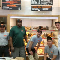 <p>The crew at Bagelman takes a break from baking to show off the wide selection of bagels at the Brookfield and Danbury locations.</p>